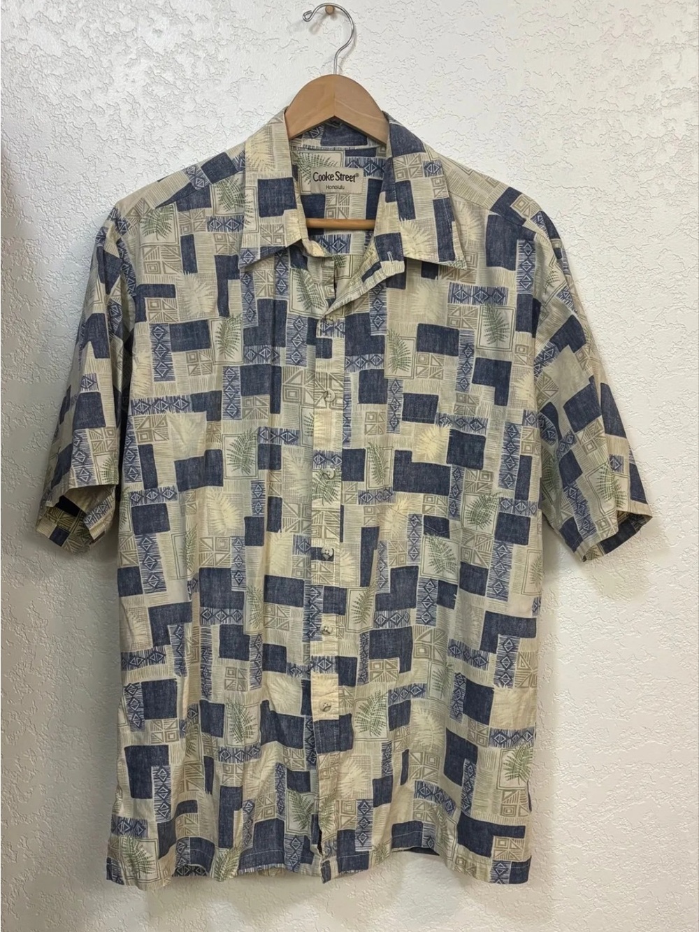 Cooke Street Honolulu blue and beige Hawaiian shirt with tropical leaf pattern.